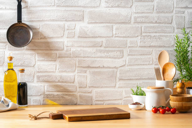 istock Wooden kitchen counter with cutting board and kitchen utensils on it . Copy space. 2184915367