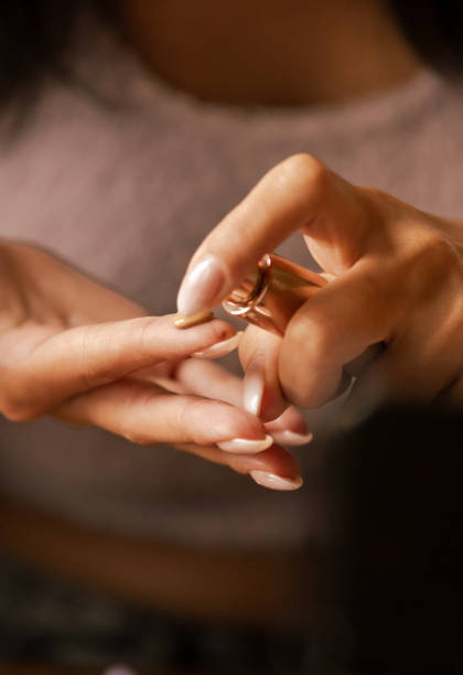 Beautiful female hand with pink nail polish manicure and ring.