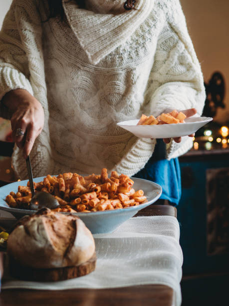 istock Woman serving hot pasta for christmas dinner 2184918374