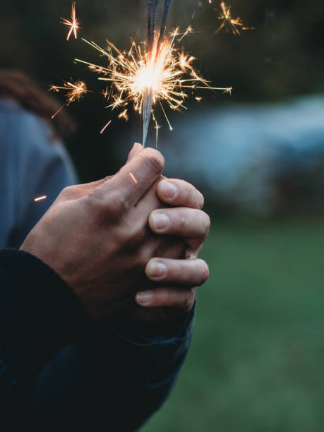 istock Hands holding a burning sparkler at dusk 2184918414
