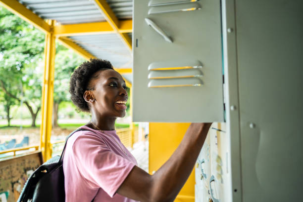 istock Young woman using locker room at the university 2184918961
