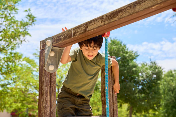 istock child playing in an outdoor playground 2184919396
