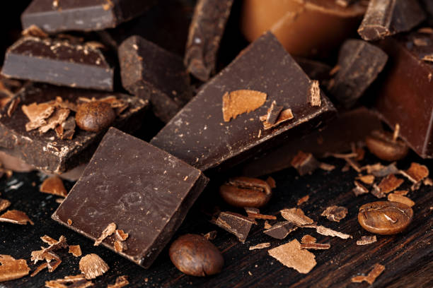istock Chocolate pieces and candy on dark wooden table. 2184919542