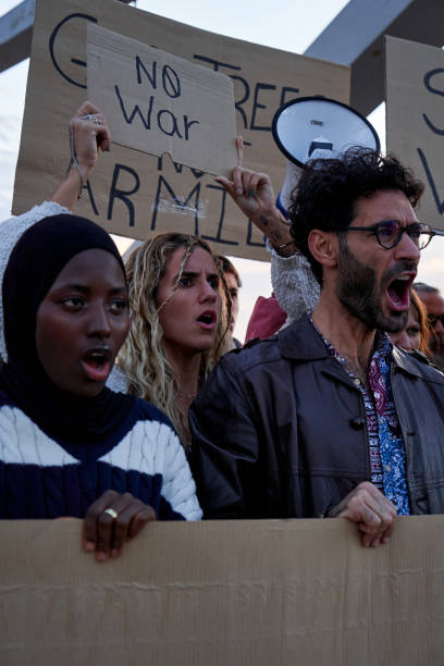 istock Group of multiethnic people protesting against violence, screaming No to War. 2184921447