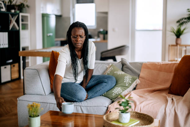 istock Casually clothed woman relaxing on a sofa at home 2184924226
