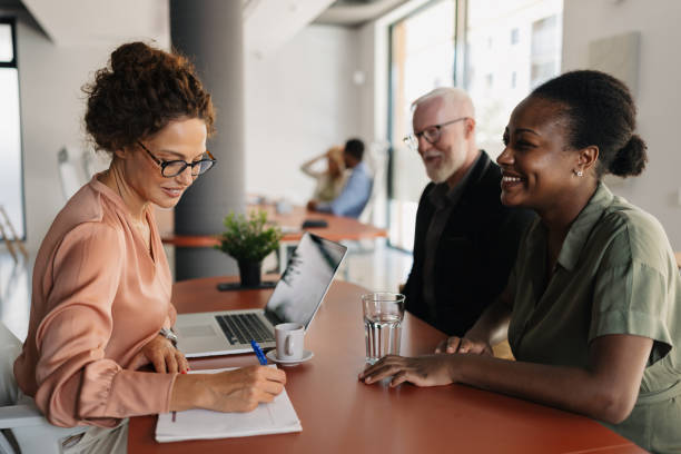 istock Business meeting with three smiling professionals. 2184925001