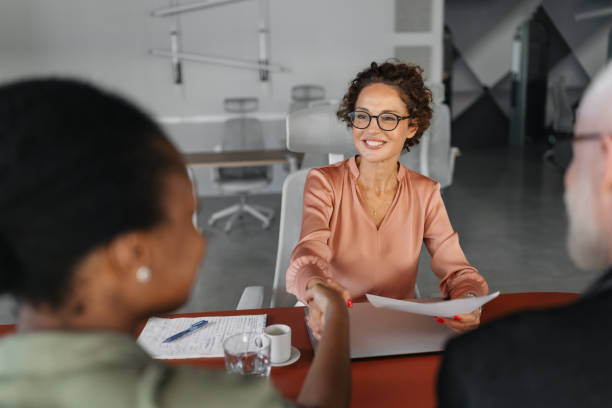 istock Woman shakes hands during professional office meeting. 2184925145