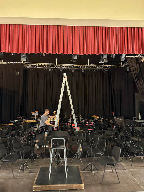 istock Technicians preparing the theater stage for a concert 2184928358
