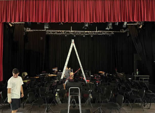 istock Technicians preparing the theater stage for a concert 2184928383