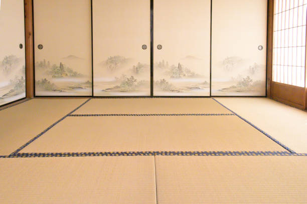 Light filtering in through gaps in the fixtures.A gap has appeared in the fixtures of an old Japanese house, allowing the morning sun to filter in onto the tatami mats.