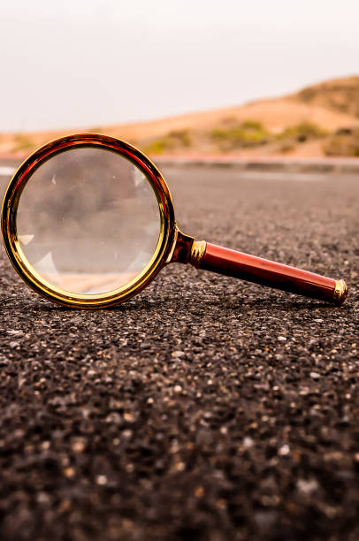 istock A magnifying glass is on the ground 2184934091