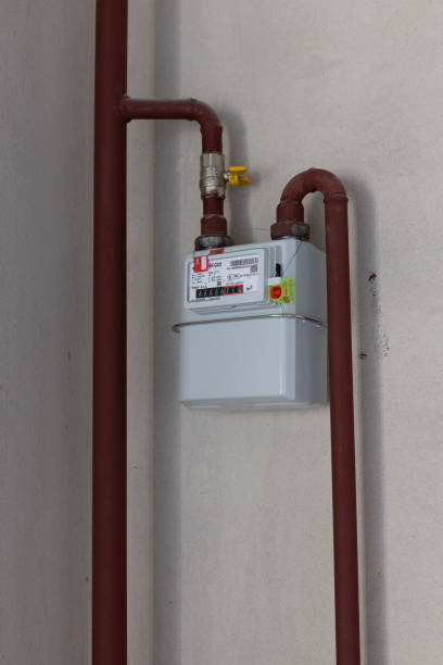 istock White sealed wall gas counter with gas pipes. 2184934624