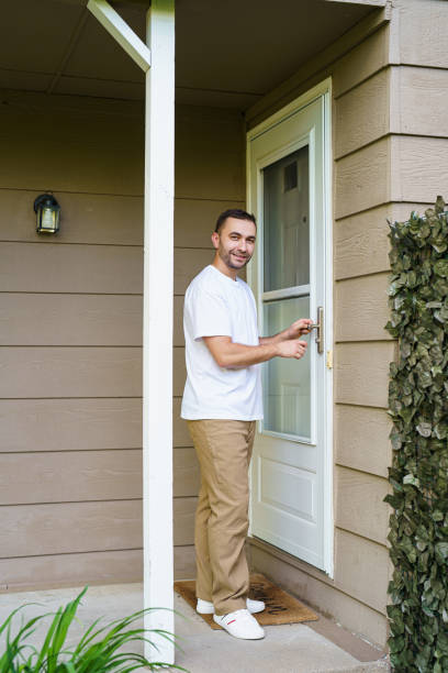 istock Man with key opening front door oh his house 2184934796