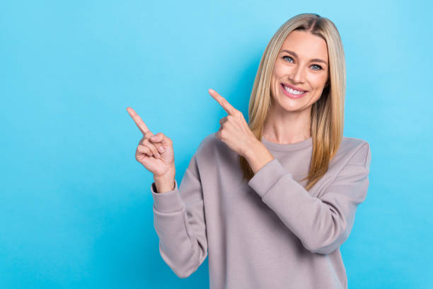 istock Portrait of cheerful cute lady wear stylish pastel pullover two arm direct empty space nice discount isolated on blue color background 2184936074