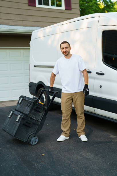istock Young handsome handyman with tools box near trunk outdoors 2184941773