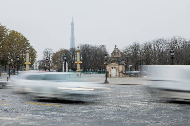 Rush hour traffic at the end of the day in Paris, with the Eiffel Tower in the distance