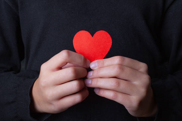 istock Girl holding a red heart in her hands. 2184943294