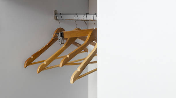 istock Empty  woode hangers in the wardrobe. White blank space for design. Empty closet 2184944895