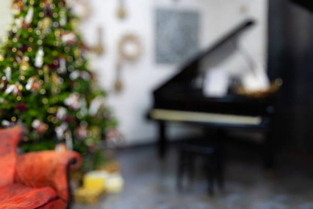 Decorated Christmas tree near armchair for design purpose