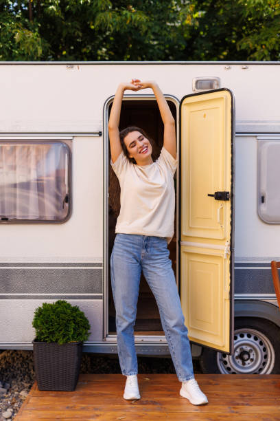 istock Pretty woman on a road trip with her camper taking a break at sunset 2184946921