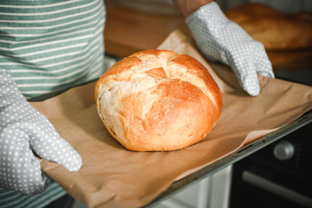 istock man bakes homemade bread 2184949371