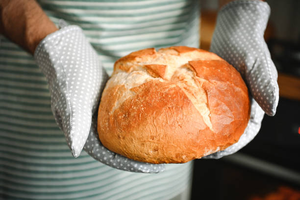 istock man bakes homemade bread 2184949417
