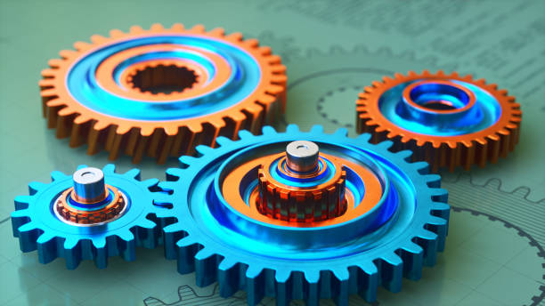 istock Close-up on colorful metallic gears on a green surface with a blueprint 2184951773