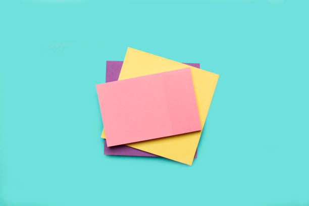 istock A pile of colored paper notes on a light blue background 2184953341