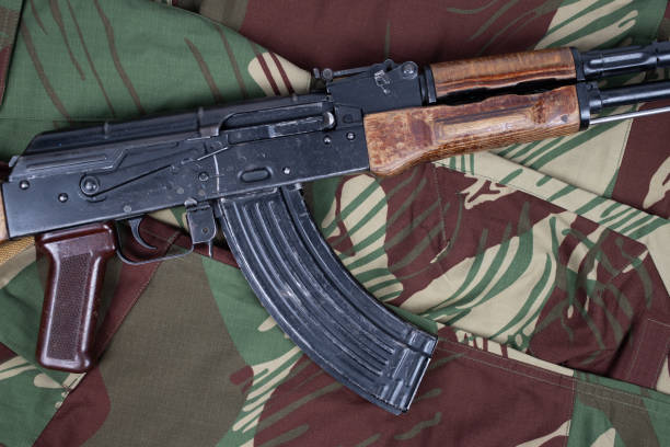 istock AK assault rifle on camo uniform background 2184955889