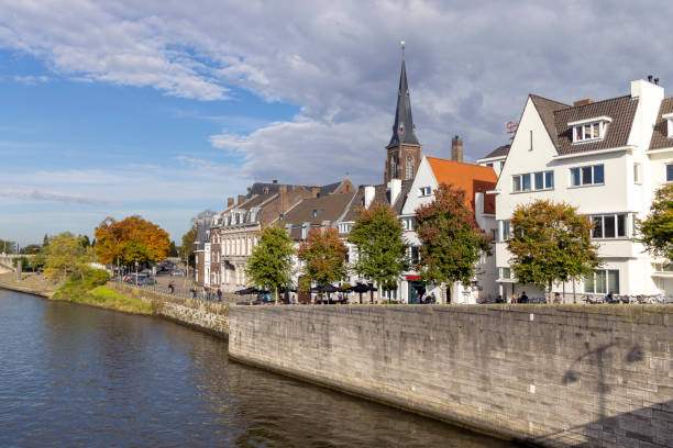 Maastricht, Netherlands - October 25, 2024: City view from one of the bridges crossing the river Meuse on a sunny afternoon.
