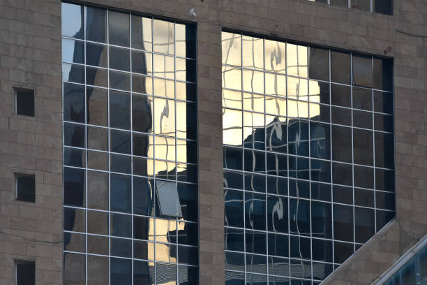 istock Architecture of a modern office building, construction background. Facade glass windows of a corporate center. Modern commercial buildings exterior. 2184957787