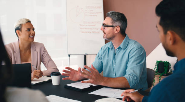 istock Businessman, presentation and discussion for company, training and mentorship with workshop planning. Whiteboard, meeting and collaboration for growth, future goals and project research communication 2184958309