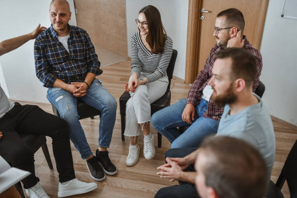 istock Mixed Gender Group Sitting in Circle in Group Therapy Each Sharing Their Stories 2184958330