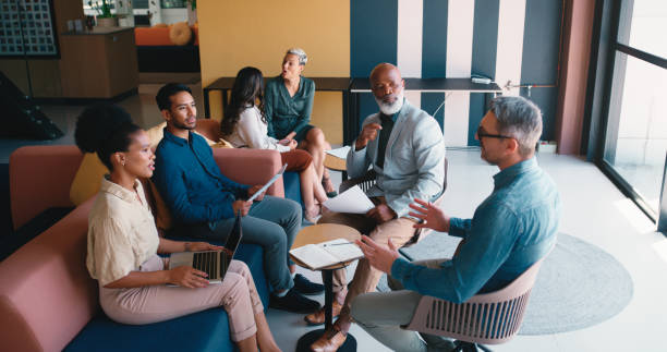 istock Business people, tech and sofa in office meeting with web designer and discussion for ux update on website. Diversity, staff and professional with teamwork and collaboration together with internet 2184958455