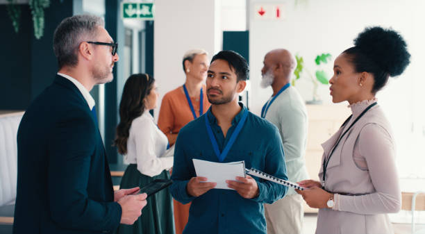 istock Documents, strategy and teamwork with employee people in office together for collaboration or discussion. Lanyard, meeting and training with business group at conference or tradeshow for planning 2184958649
