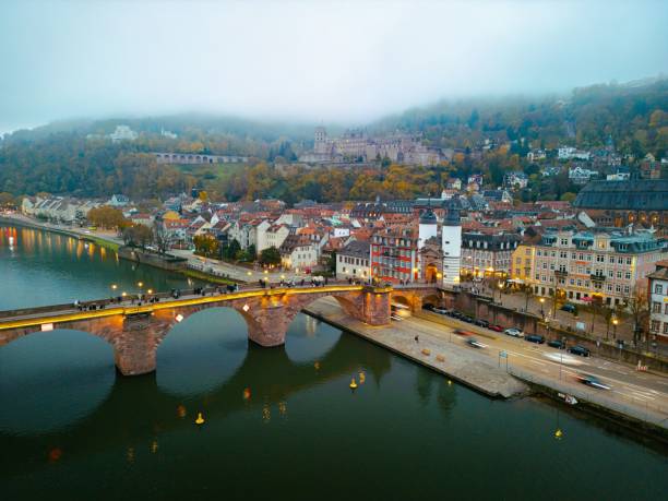 Aerial view of Heidelberg, Germany with the Old Bridge and Heidelberg Castle on a misty day.