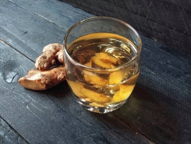 istock Boiled ginger solution water in glass on wooden table 2184960377
