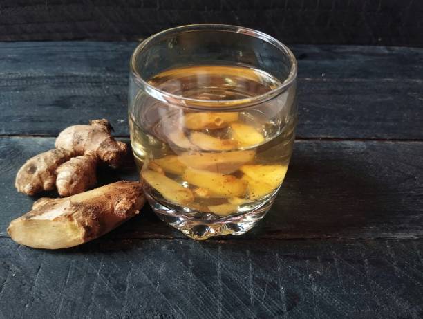 istock Ginger boiled water solution in glass on the wooden table 2184960386