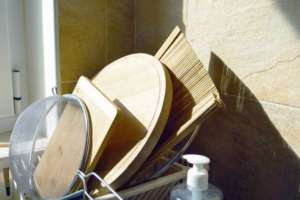 istock Everyday moments: clean dishes illuminated by the sun's rays, stacked in the dryer. 2184961334