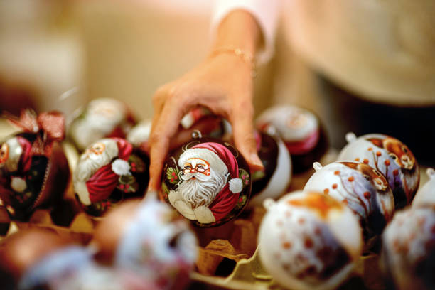 Close-up of a woman holding painted Christmas balls stock photo