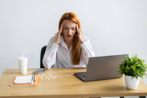 istock Worried fatigued business having headache at work feeling stress at workplace looking at laptop computer in office. 2184965460