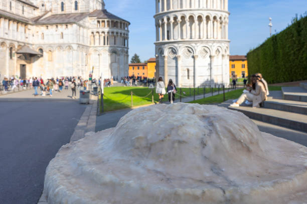 Marble column with the Tower of Pisa in the background