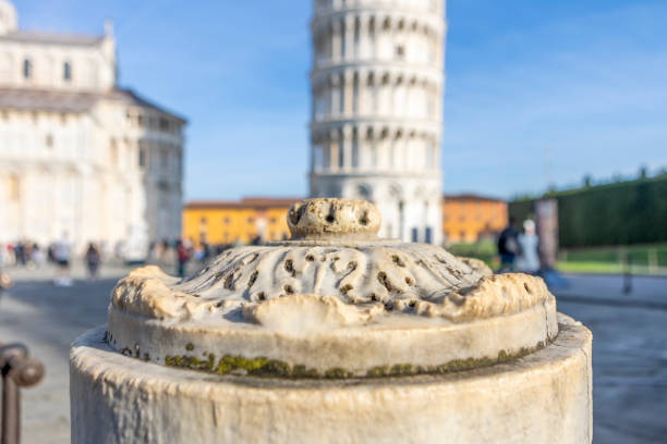 Marble column with the Tower of Pisa in the background