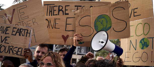 istock Global warming banners. Activist people protesting for the earth warning about environmental problem 2184969651