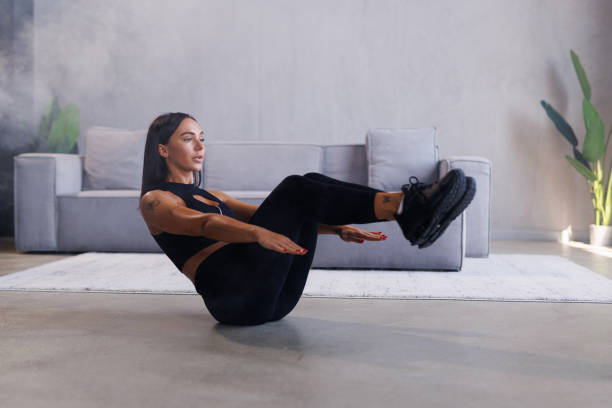 istock Young fit woman doing a workout at home and exercises for the abs 2184971010