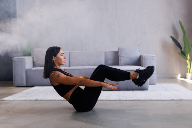istock Young fit woman doing a workout at home and exercises for the abs 2184971360
