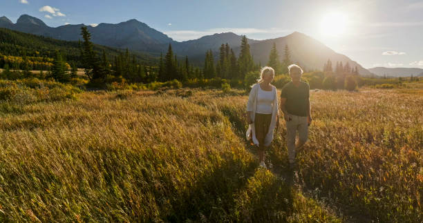 istock Mature couple hike in meadow in autumn 2184971662