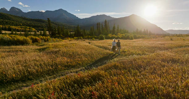 istock Mature couple hike in meadow in autumn 2184971688