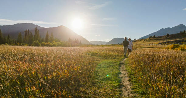 istock Mature couple hike in meadow in autumn 2184971808