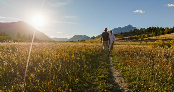 istock Mature couple hike in meadow in autumn 2184971842